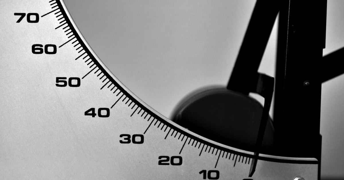 Close view of a black-and-white gauge dial marked from 70 down to 10, with the needle's pivot on the right